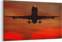 Schilderij - Vliegtuig vliegt terwijl de zon ondergaat — 100x70 cm