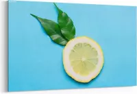 Schilderij - Sliced lemon on blue background. Top view — 90x60 cm